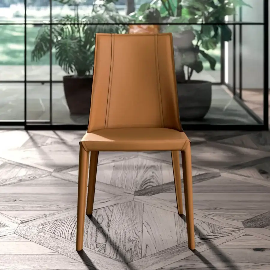 Distinguished Ozzio Italia Loren chair upholstered in medium tan rigid leather with refined vertical seams