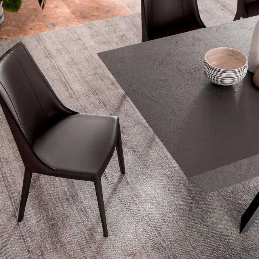 Superior Ozzio Italia Loren chair upholstered in dark brown rigid leather with a smooth finish and slender metal legs