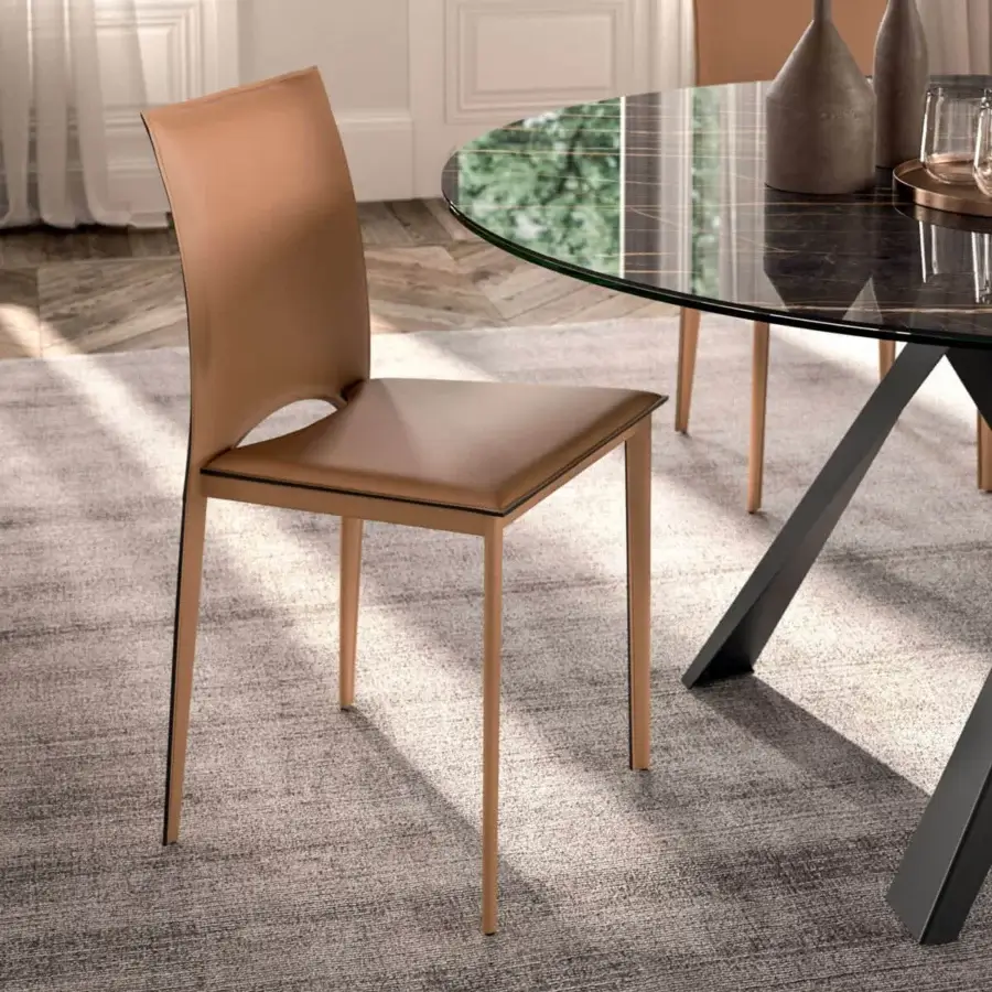 Harmonious Ozzio Italia Viva chair with gently curved backrest and square seat in warm tan leather-like material with smooth matte finish