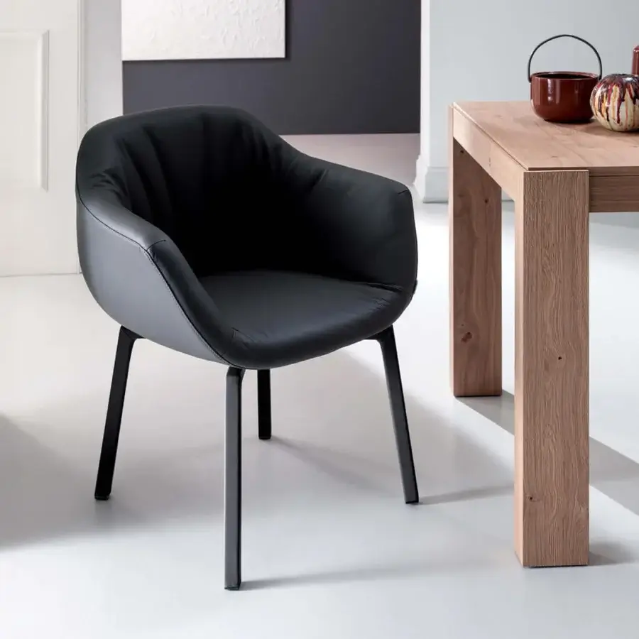Distinguished Ozzio Italia Eliot armchair with sleek black leather-like upholstery and slender matte black metal legs