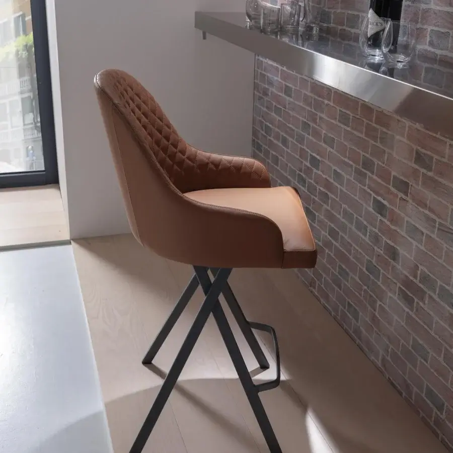 Superior Ozzio Italia Febo stool crafted with quilted light tan synthetic material and a sleek black metal base