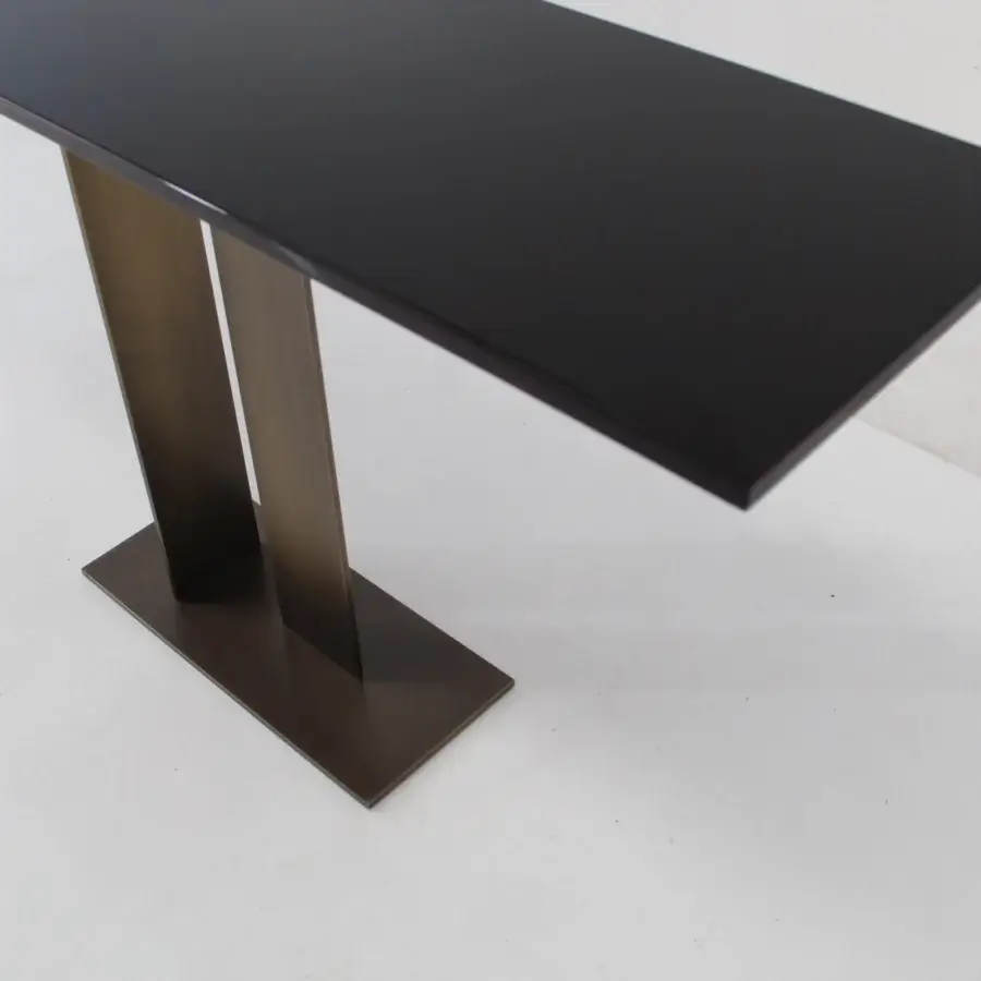 Superior Casa Casati Berlino console with glossy wood top and bronze-toned metal legs exhibiting orange lacquer detail