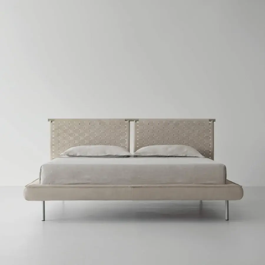 Exceptional Cierre1972 Jared bed with handwoven leather headboard and cylindrical matte metal legs