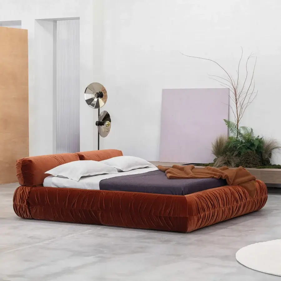 Harmonious Cierre1972 Option bed with warm brown ruched textile upholstery and geometric form evoking a contemporary aesthetic