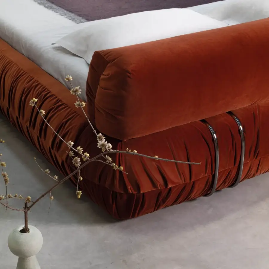 Exclusive Cierre1972 Option bed with rust-colored gathered textile upholstery and sleek metal detailing crafted in Italy