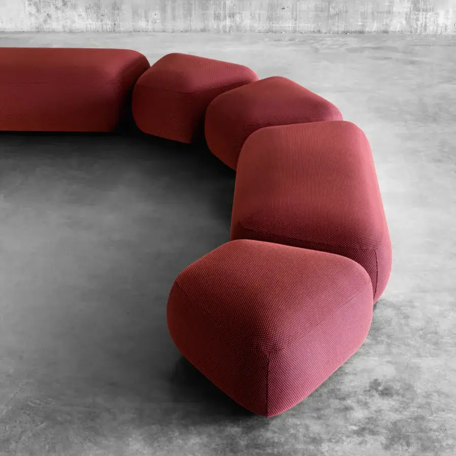 Exceptional Miniforms Botera ottoman with a squishy seat upholstered in finely textured terracotta textile and rounded form