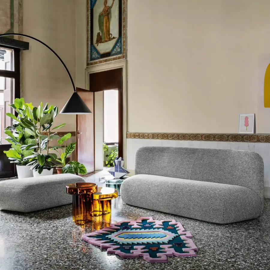 Distinguished Miniforms Botera sofa, a modular seating system upholstered in textured medium-gray textile with a curved silhouette