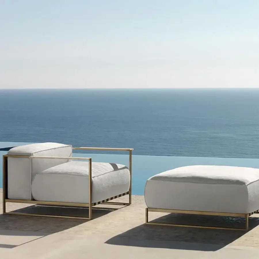 Superior Talenti Casilda ottoman with a golden stainless steel frame and light gray weather-resistant cushions crafted for outdoor use