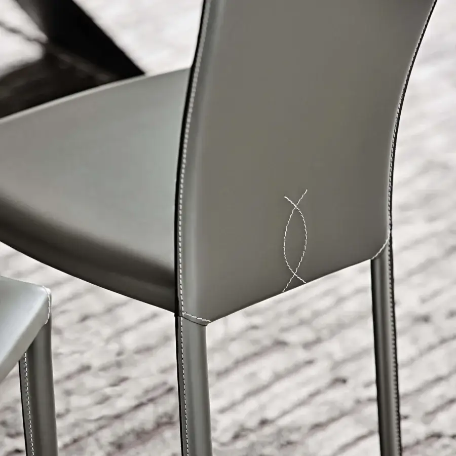 Elegant Cattelan Italia Nina chair crafted in muted gray real leather with smooth matte finish and decorative stitching