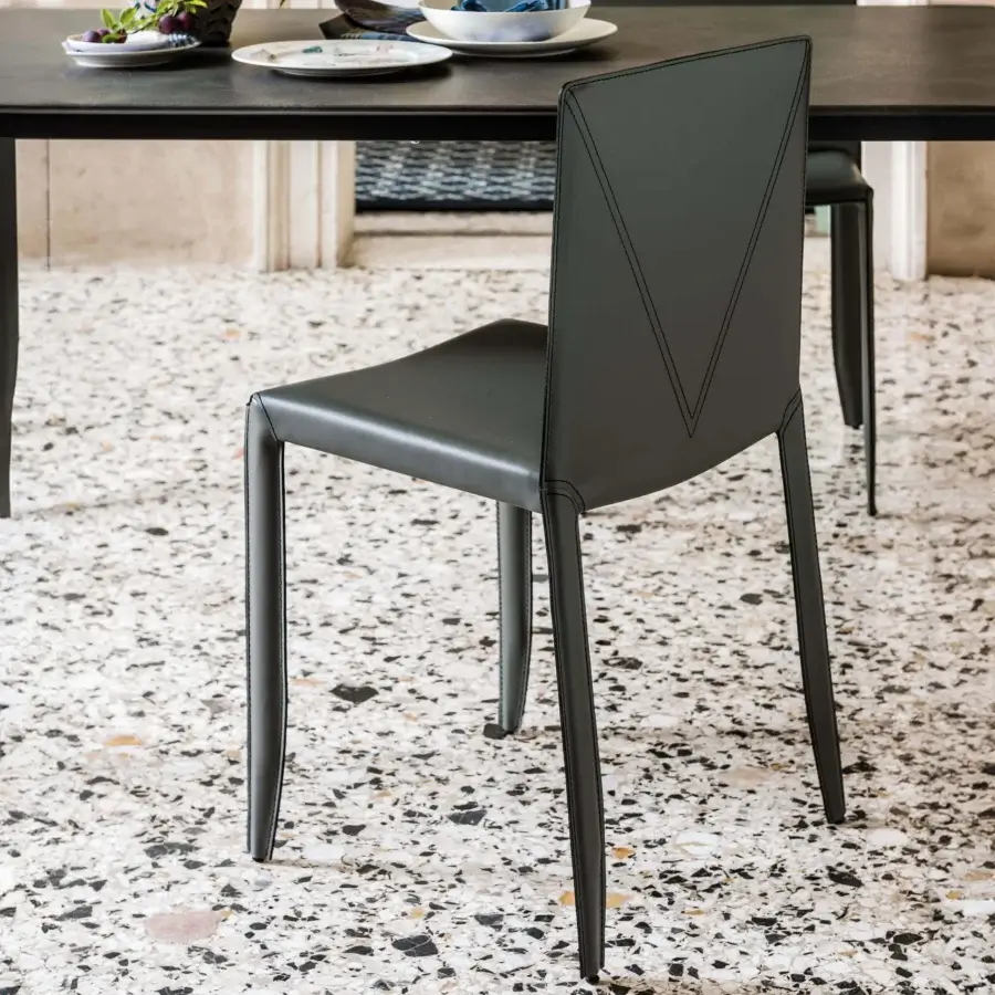 Exceptional Cattelan Italia Piuma chair in dark gray leather-like material with angular lines and a distinctive stitched V-shape backrest