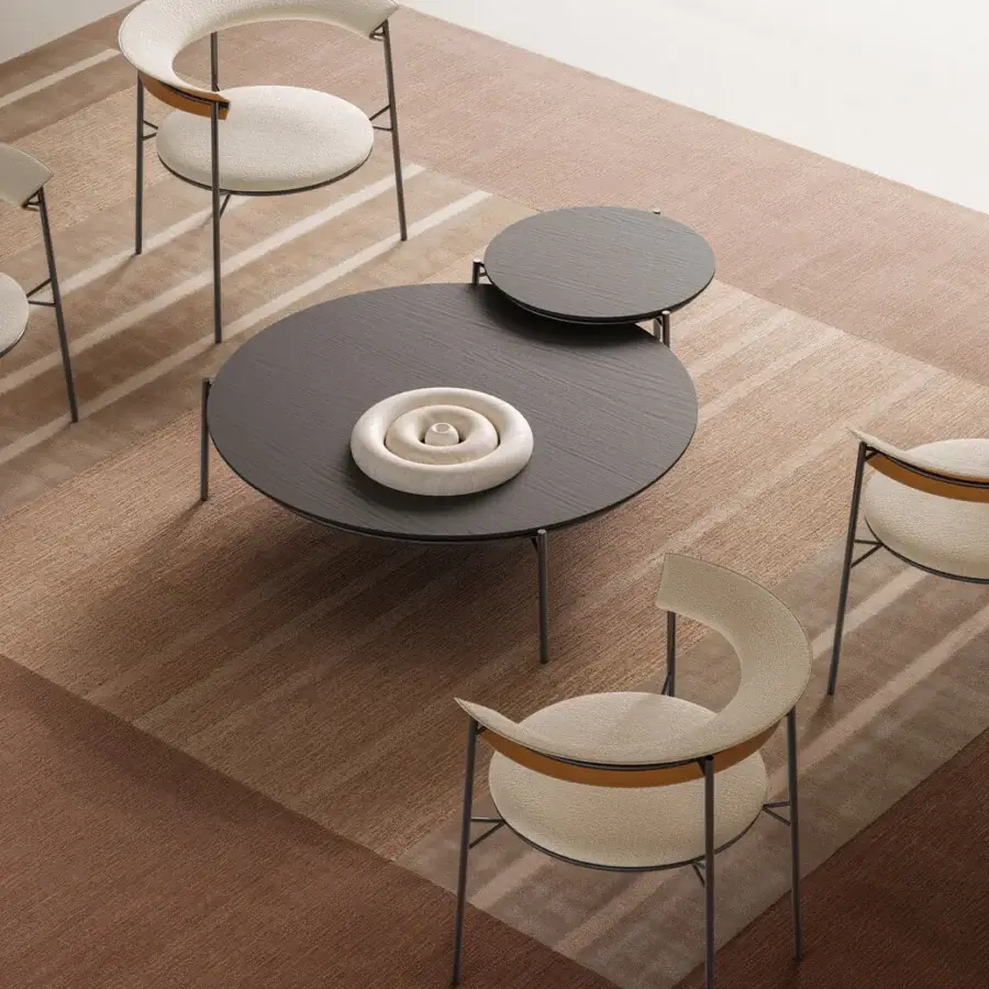 Distinguished MDF Italia Cantle lounge chair with curved backrest upholstered in textured light beige textile and graphite grey powder coated metal frame