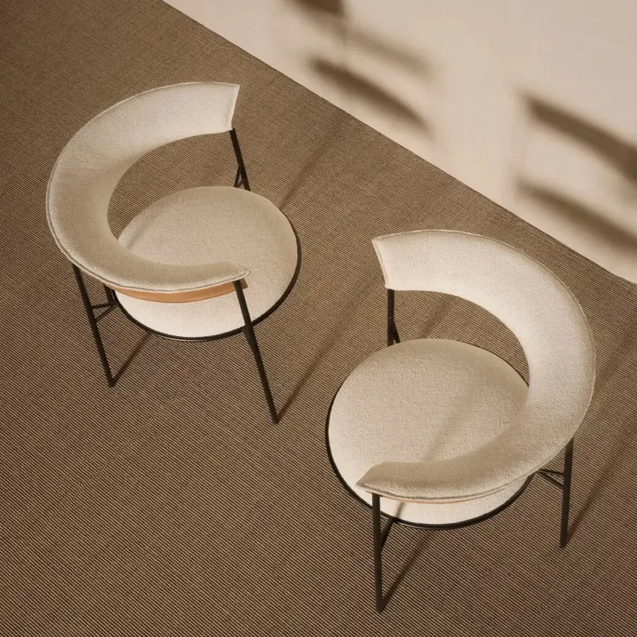 Exclusive MDF Italia Cantle lounge chair with curved backrest upholstered in light beige textured fabric and graphite grey tubular metal frame
