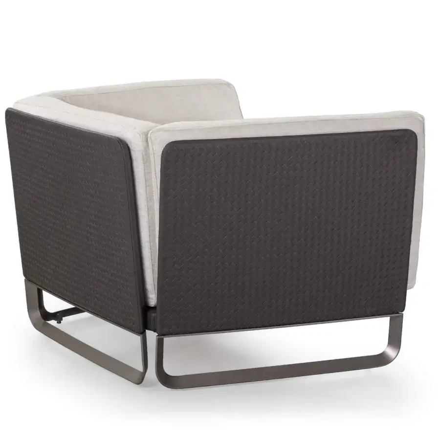 Exceptional Turri Milano lounge chair with woven leather structure and light beige textile upholstery with curved brushed nickel legs