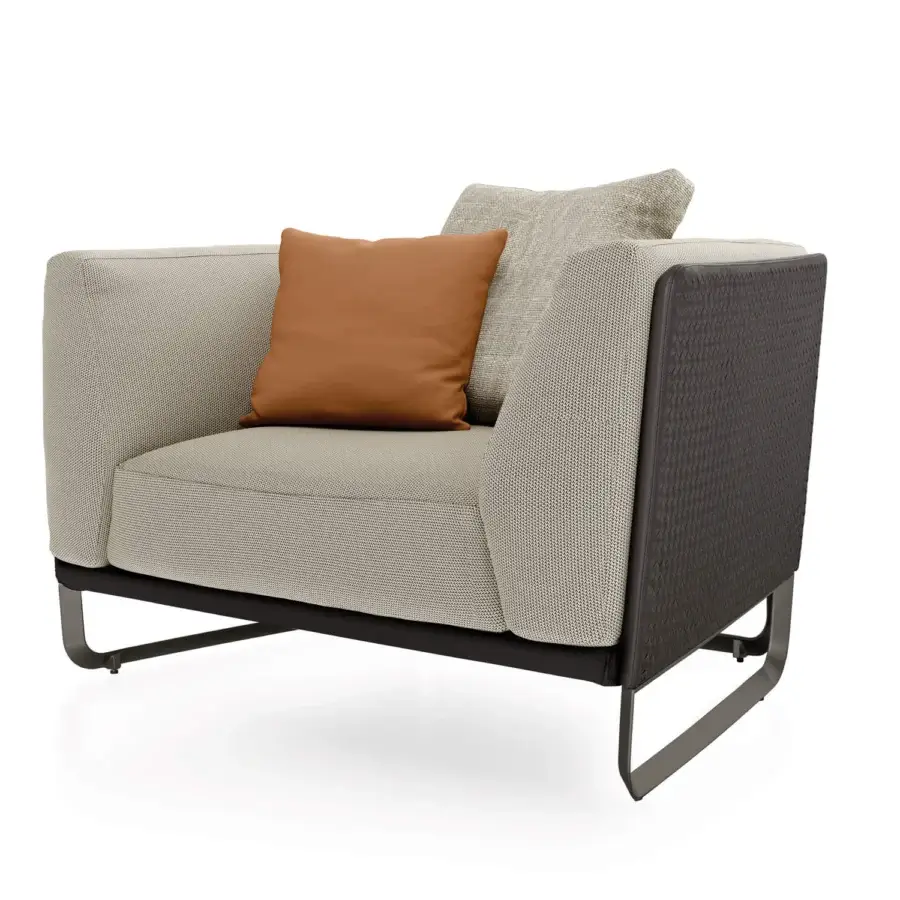 Distinguished Turri Milano lounge chair with woven leather structure and light beige textile upholstery supported by curved brushed nickel metal legs