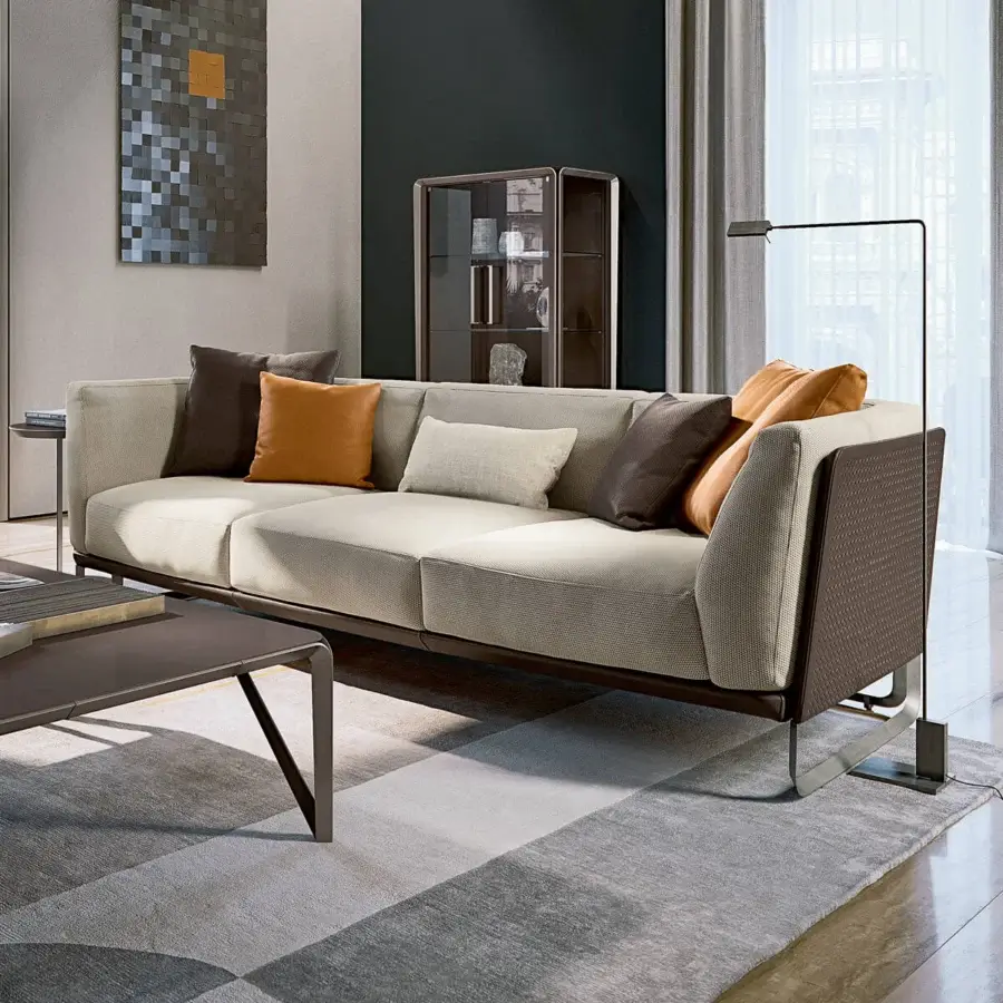 Lavish Turri Milano sofa with woven dark brown leather frame and plush cream textile seating accented with orange