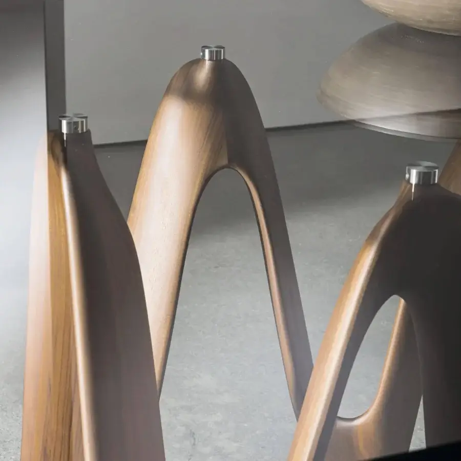 Exceptional Sovet Italia Lambda table with a tempered glass top and sculptural solid Canaletto walnut wood base in a light to medium brown finish