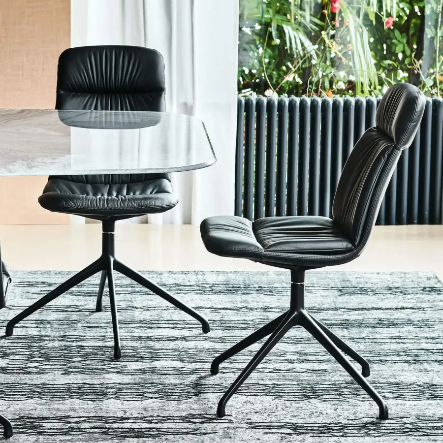 Distinguished Cattelan Italia Kelly chair with black leather upholstery, voluminous folds and a slender aluminum base