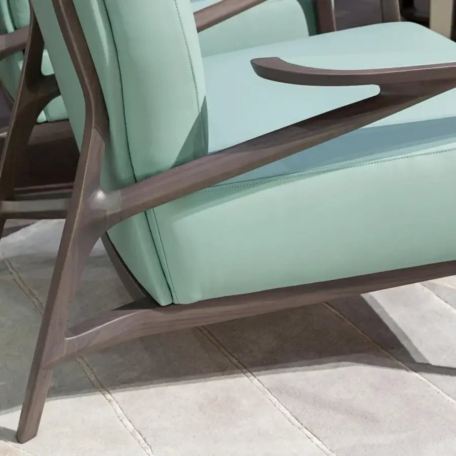 Distinguished Turri Vine lounge chair with light greenish-blue fabric upholstery and a branched natural wood frame