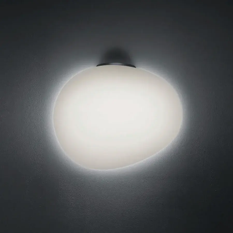 Distinguished Foscarini Gregg Semi wall lamp in frosted hand-blown glass creating a soft ambient glow with a bright white finish