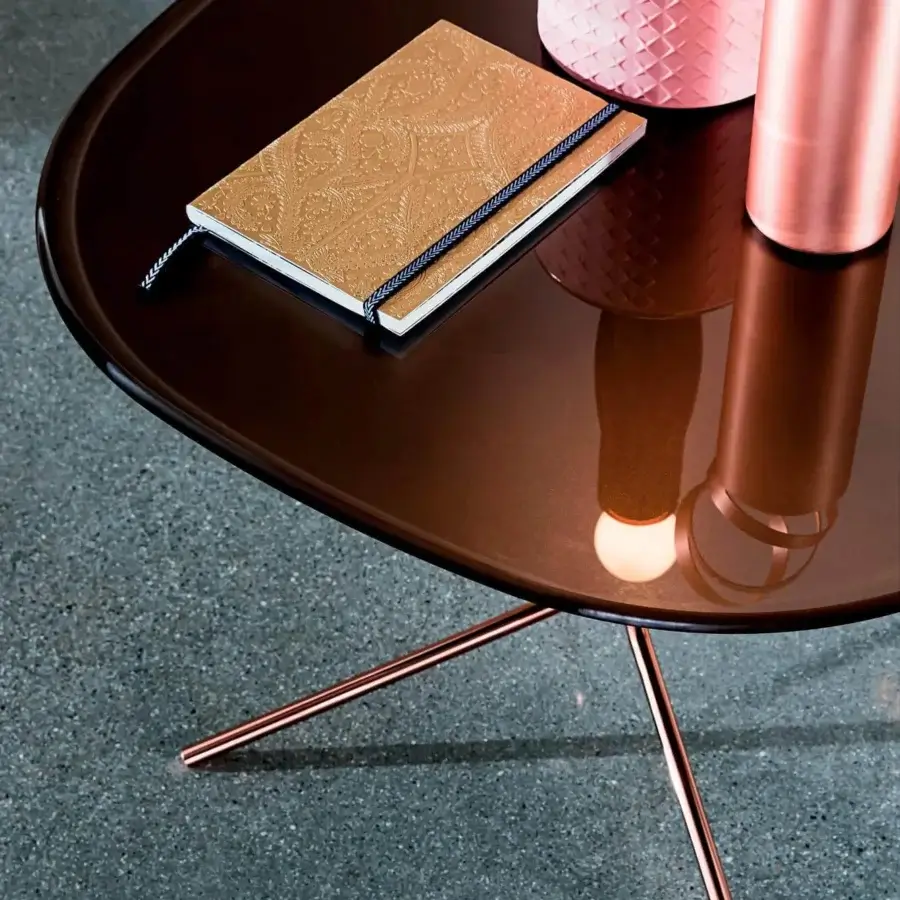 Captivating Sovet Italia Genius coffee table with a burnished metal base and dark brown lacquered top exhibiting curved lines