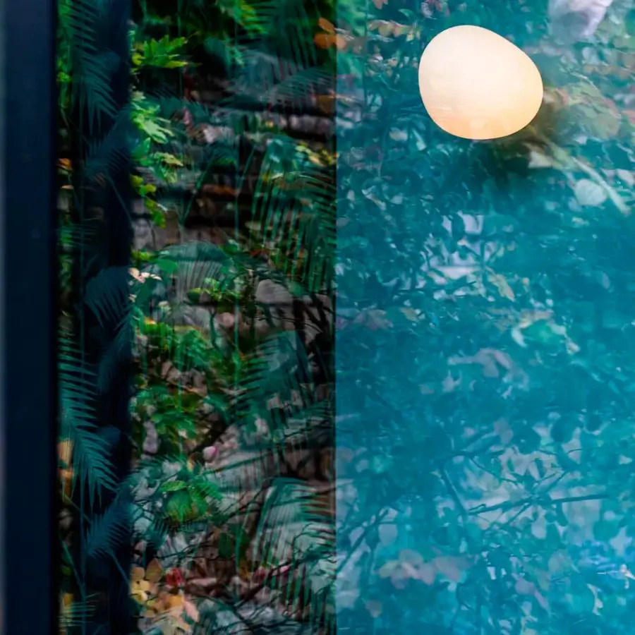 Distinctive Foscarini Gregg Outdoor wall lamp crafted in acid-etched blown glass with a soft off-white hue emitting a warm glow