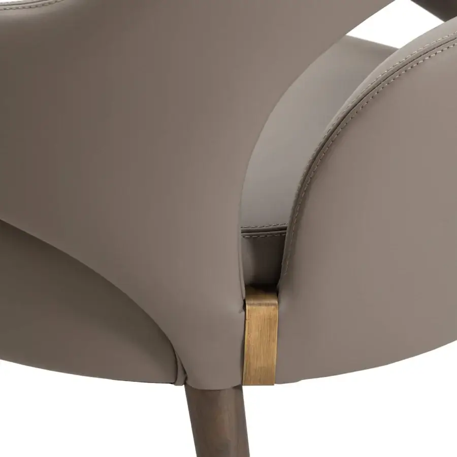 Lavish Turri Vine armchair showcases arched opening and wing-like armrests crafted in light brown leather with gilded natural wood legs