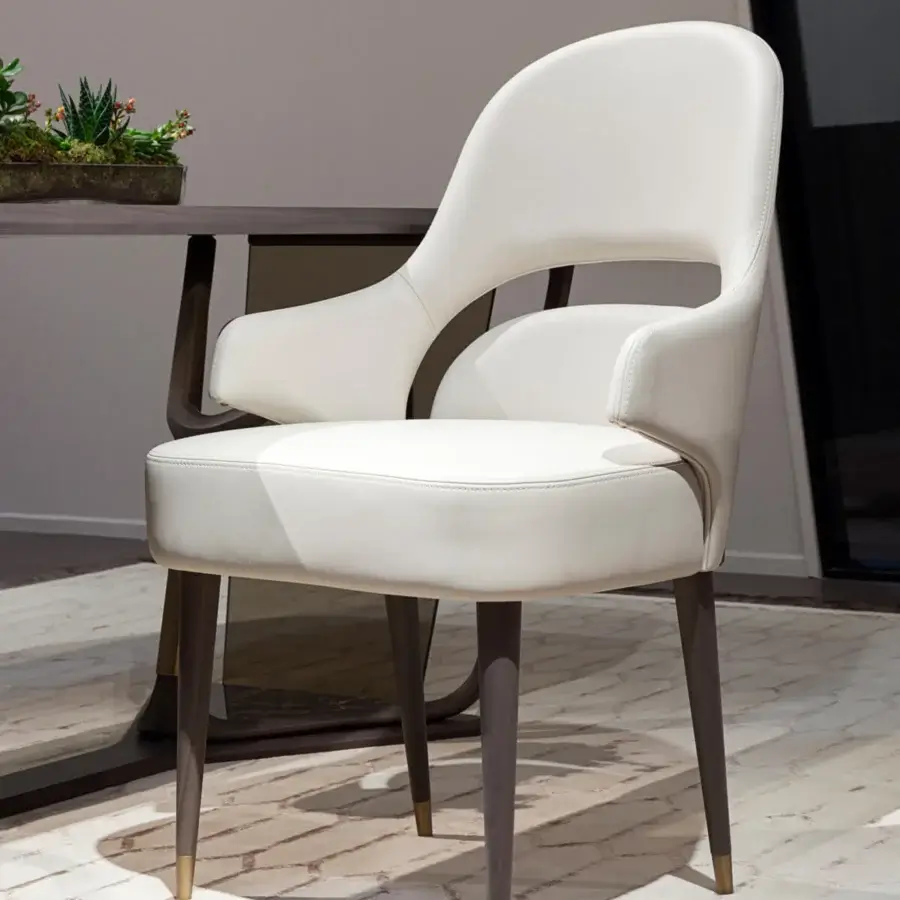 Distinguished Turri Vine armchair with arched opening and wing-like armrests upholstered in white synthetic material with brushed gold metal details
