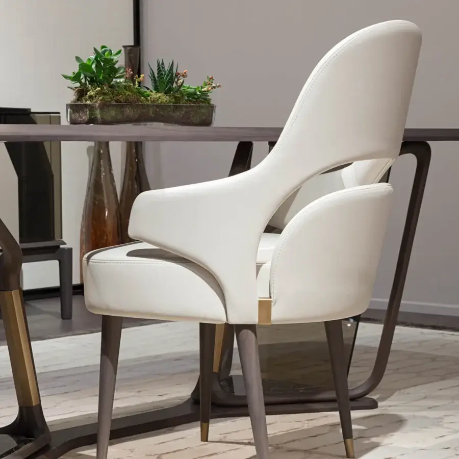 Exclusive Turri Vine armchair with significant arched opening and wing-like armrests upholstered in light off-white with natural wood and brushed gold accents