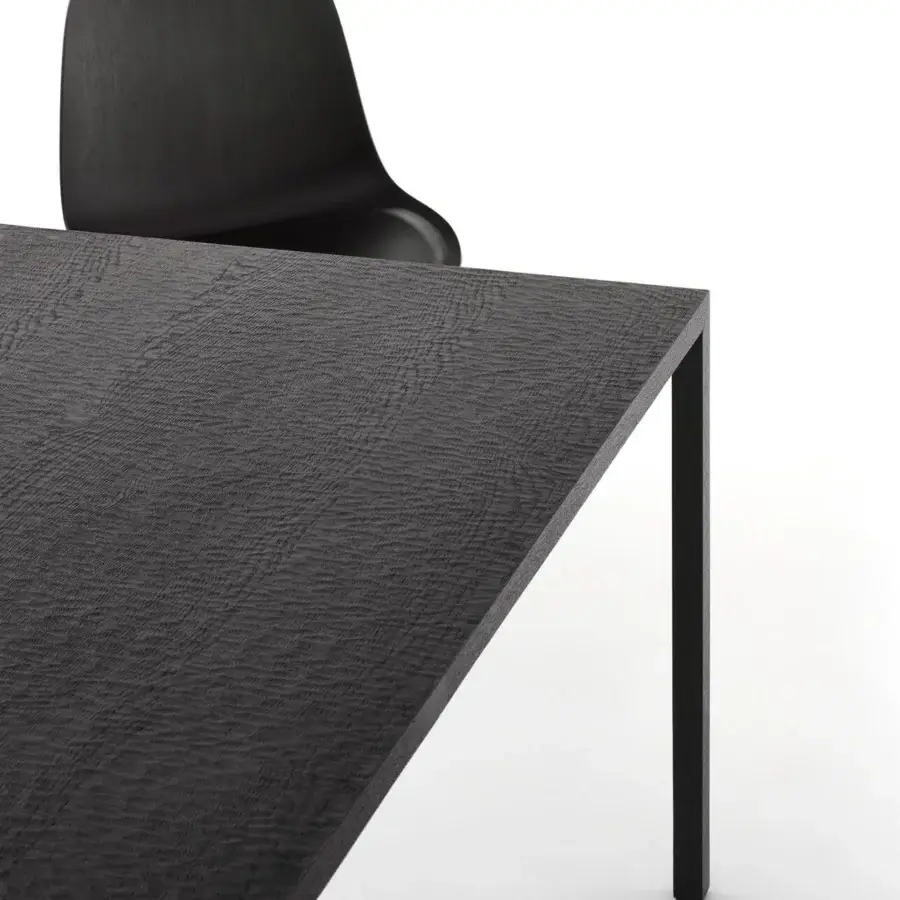 Elegant MDF Italia Tense Material Heritage table crafted in dark natural-stained oak with sleek steel legs and intensely tactile surface