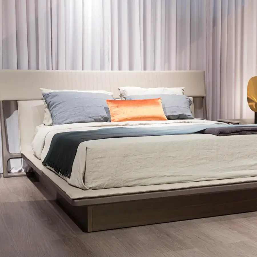 Exclusive Turri Vine bed with neutral beige textile upholstery and leather headboard evoking natural wood elements with a matte finish