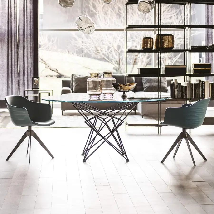 Distinguished Cattelan Italia Gordon table with round crystal top and geometrically complex dark metal base with matte finish