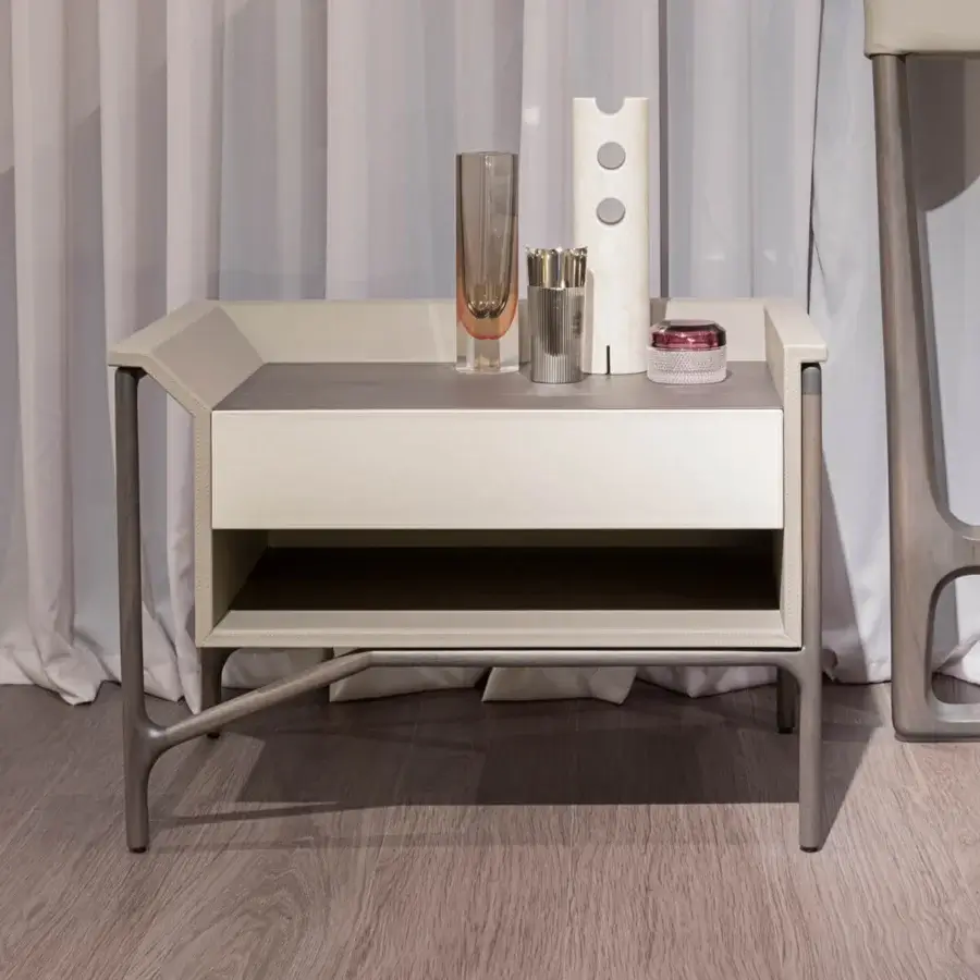 Elegant Turri Vine nightstand in light cream leather with dark gray wood, presenting an asymmetrical silhouette and metal framework