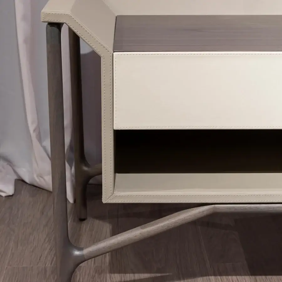 Distinguished Turri Vine nightstand with supple light cream leatherette and gray-brown wood, crafted with stitched edges and an asymmetrical silhouette