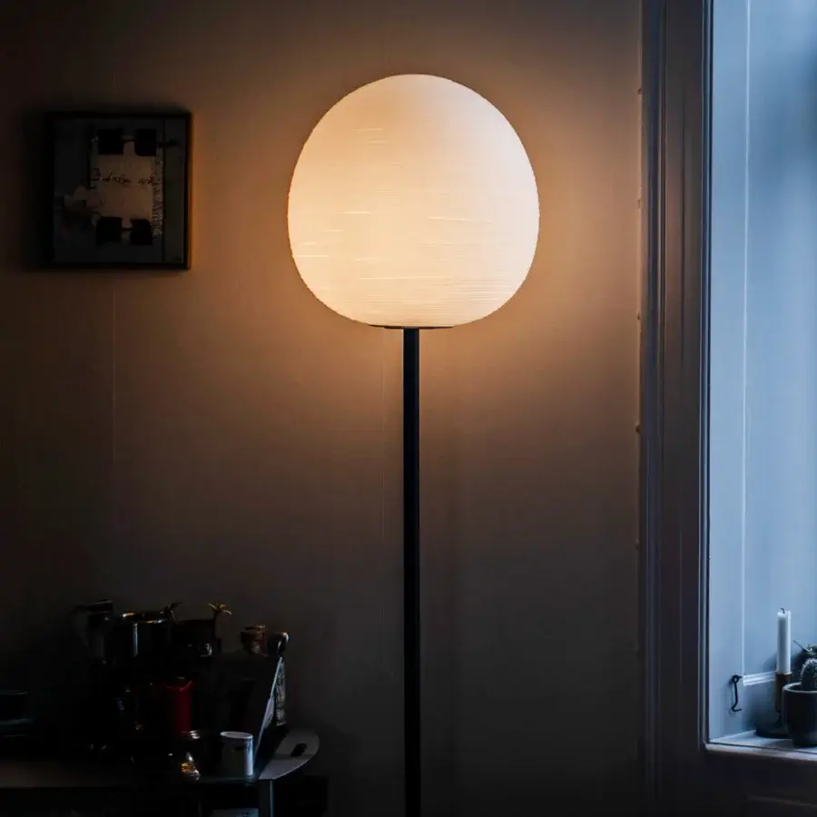Distinguished Foscarini Rituals floor lamp with ovular blown glass diffuser exhibiting a horizontally striped texture and liquid-coated metal support