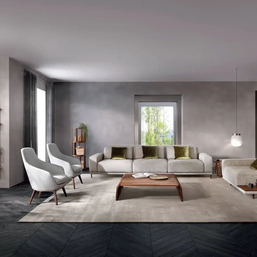Elegant Pacini & Cappellini Spring lounge chair with a solid ash wood base and light gray fabric shell with matte finish