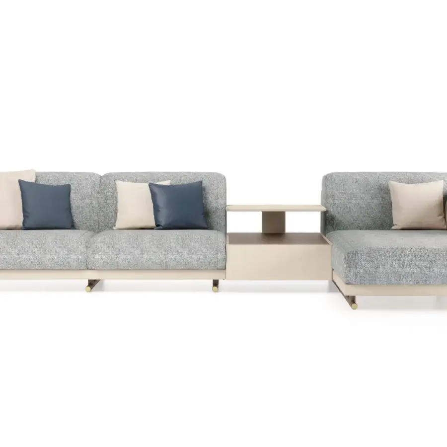 Elegant Turri Vine sectional with light grey textile upholstery, beige and dark blue cushions, plus brushed gold metal accents