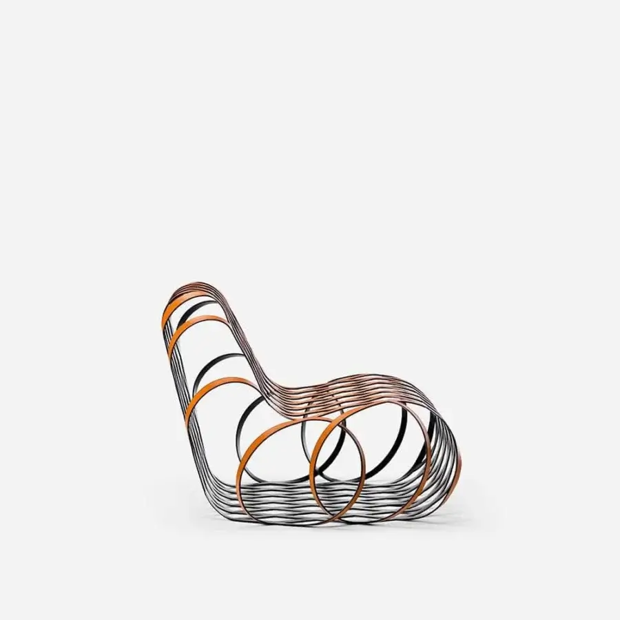 Handcrafted LaCividina Aria lounge chair with a dark steel frame and saddle leather in orange or copper hues