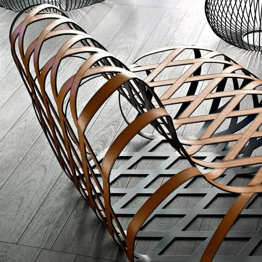 Innovative LaCividina Aria lounge chair with a black steel frame interlaced with handwoven tan saddle leather creating an open curvilinear design