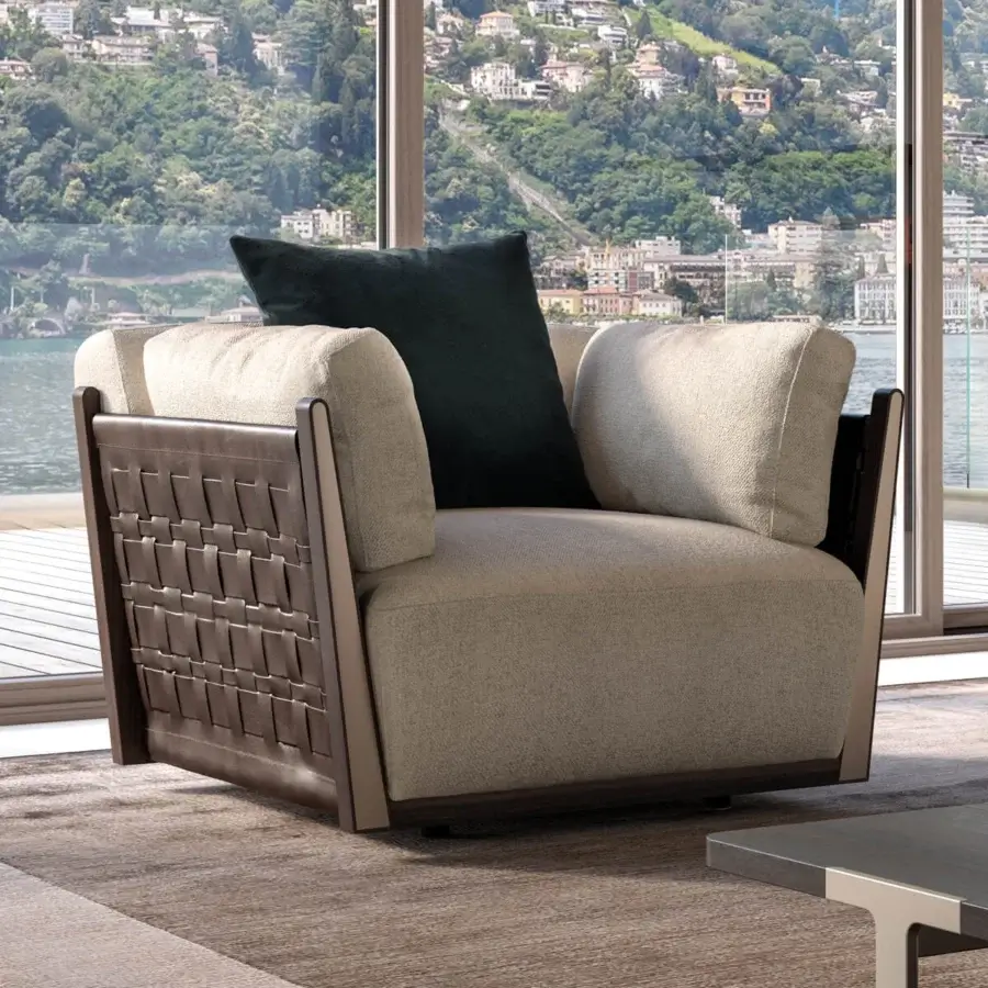 Elegant Turri Net lounge chair in light beige textile with woven brown leather paneling and Eucalyptus wood frame