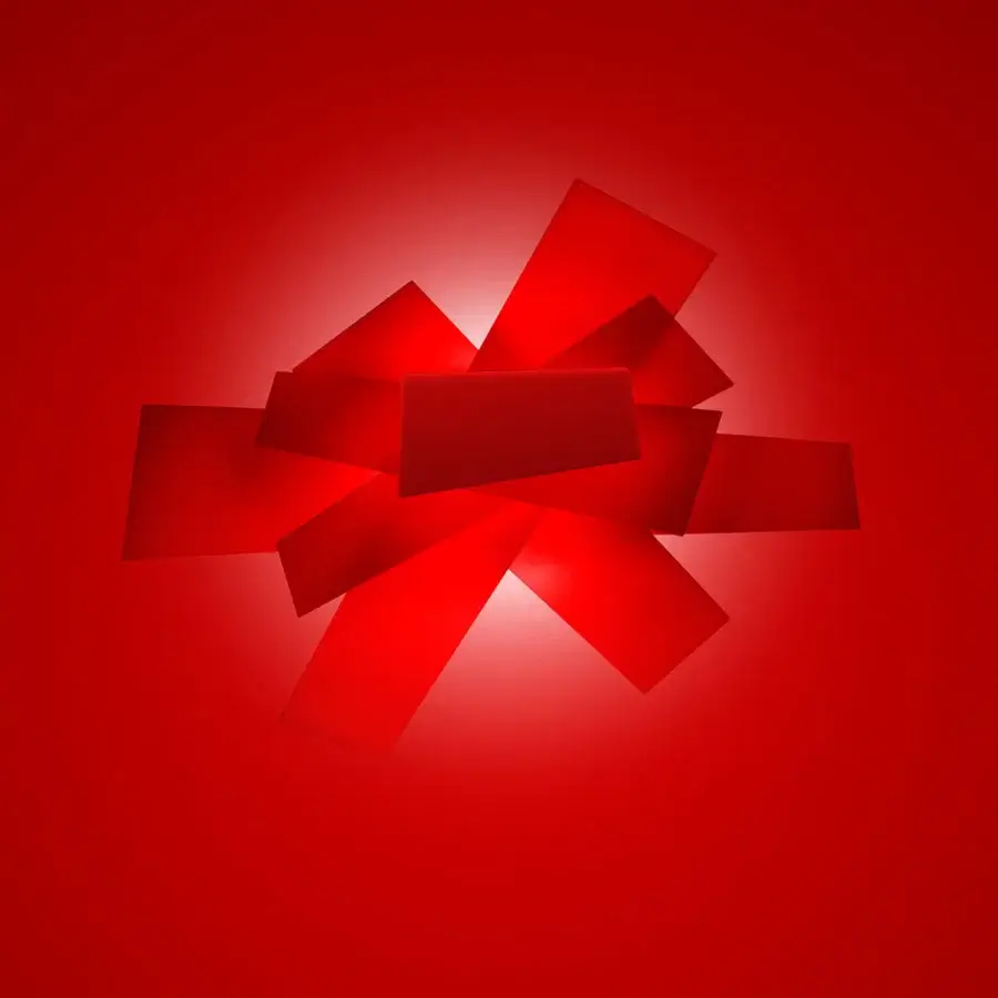 Distinguished Foscarini Big Bang wall lamp with intersecting planes of vibrant red translucent methacrylate secured with powder-coated zamak supports