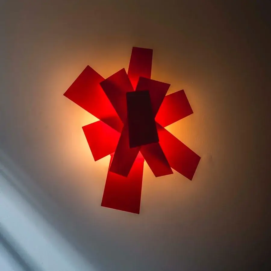 Distinguished Foscarini Big Bang wall lamp with a dynamic form crafted in red methacrylate and aluminum-color powder coating