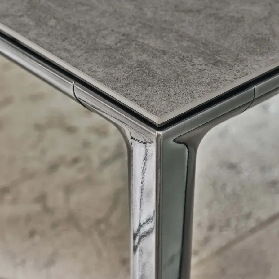 Elegant Bontempi Duke Square table with textured gray tabletop and sleek reflective metal frame legs