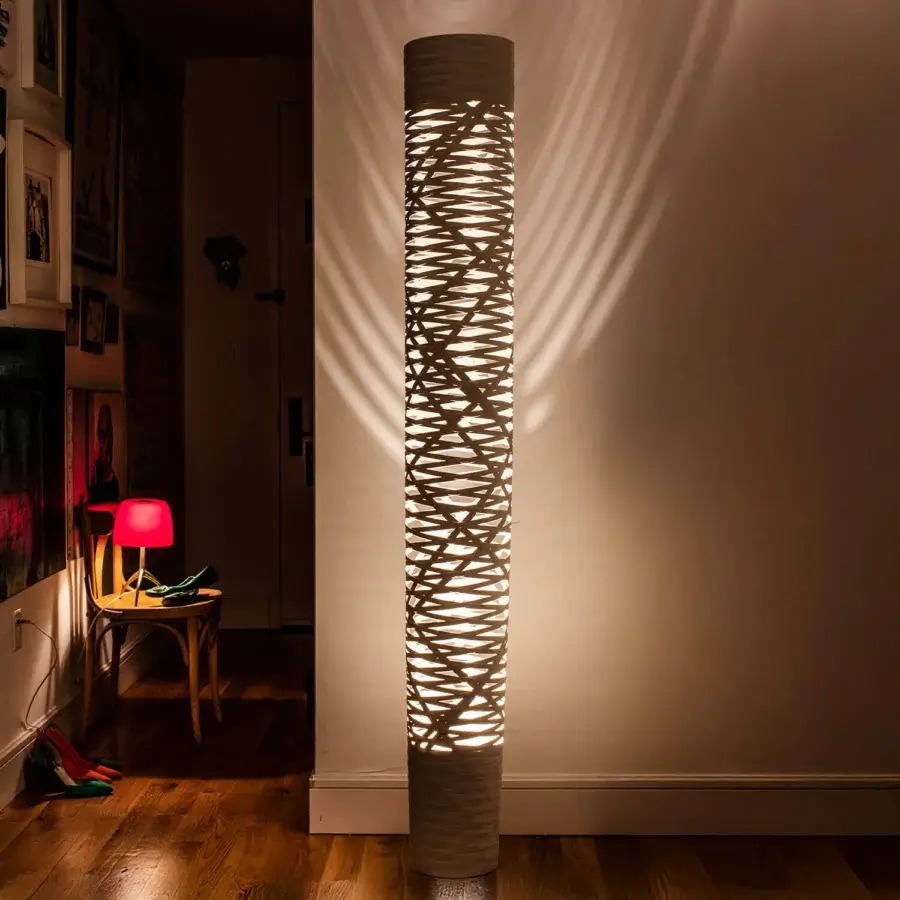 Distinguished Foscarini Tress floor lamp showcases a cylindrical form crafted in fiberglass composite with a light beige woven pattern and matte finish