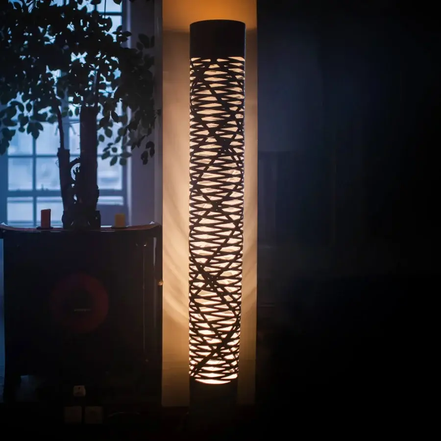 Distinguished Foscarini Tress floor lamp presents a cylindrical silhouette crafted in epoxy powder-coated fiberglass-based composite with a dark finish
