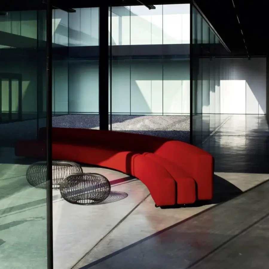Superior LaCividina Osaka sofa with modular design and organic lines upholstered in vibrant red stretch fabric with a steel structure