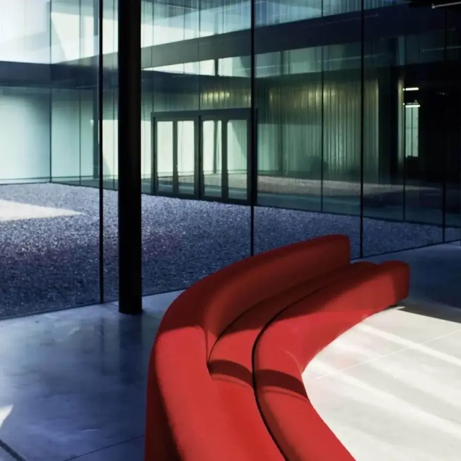 Elegant LaCividina Osaka sofa with a modular system and organic lines upholstered in vibrant red stretch fabric
