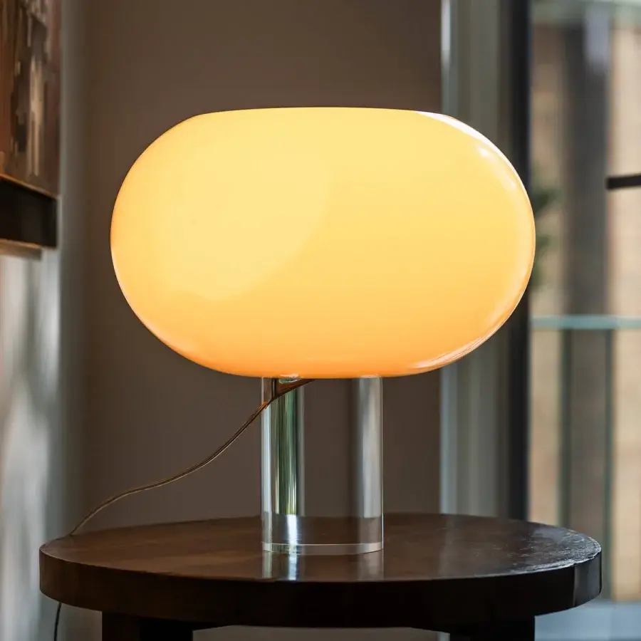 Elegant Foscarini Buds lamp with hand-blown cased glass diffuser and glossy finish in warm yellow light