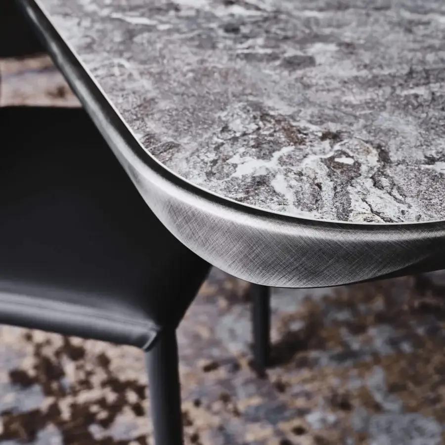 Distinguished Cattelan Italia Planer Keramik table with stone-like ceramic and lacquered rounded profile built with a dark metallic band