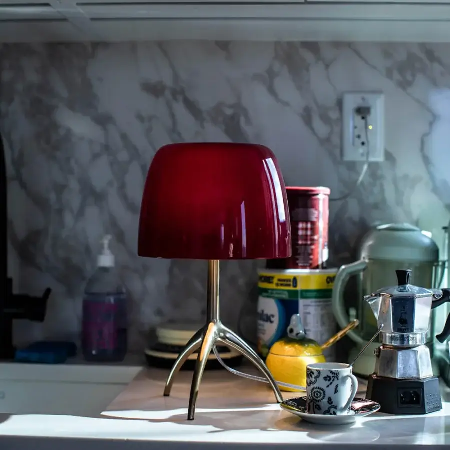 Distinguished Foscarini Lumiere lamp with hand-blown cased glass in glossy cherry red and champagne-toned aluminum base