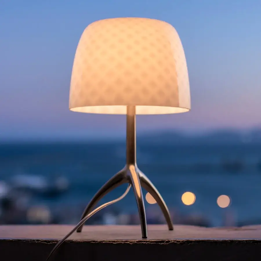 Exclusive Foscarini Lumiere table lamp with cased glass diffuser and glossy “Bulles” finish, built with a hand-finished silver toned aluminum tripod base